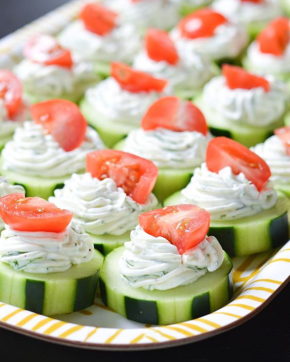 Dilly Cucumber Bites - Dilly cucumber bites are another favorite, healthy cucumber appetizer of ours. Simply top cucumber slices with dill cream cheese and yogart, the top with a cherry tomato! #cucumberappetizers #appetizers