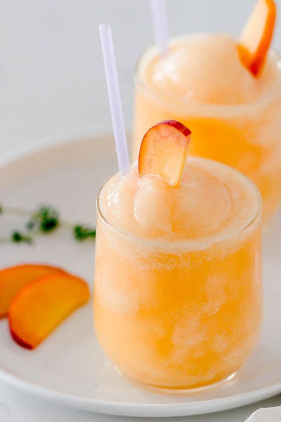 This Frozen Peach Bellini Cocktail is a light and refreshing summer cocktail. Super easy and quick to make, all you need is 5 minutes to combine the 3 ingredients and you are ready for any summer parties this year! #sumemrcocktails #summerparties #bellinicocktail