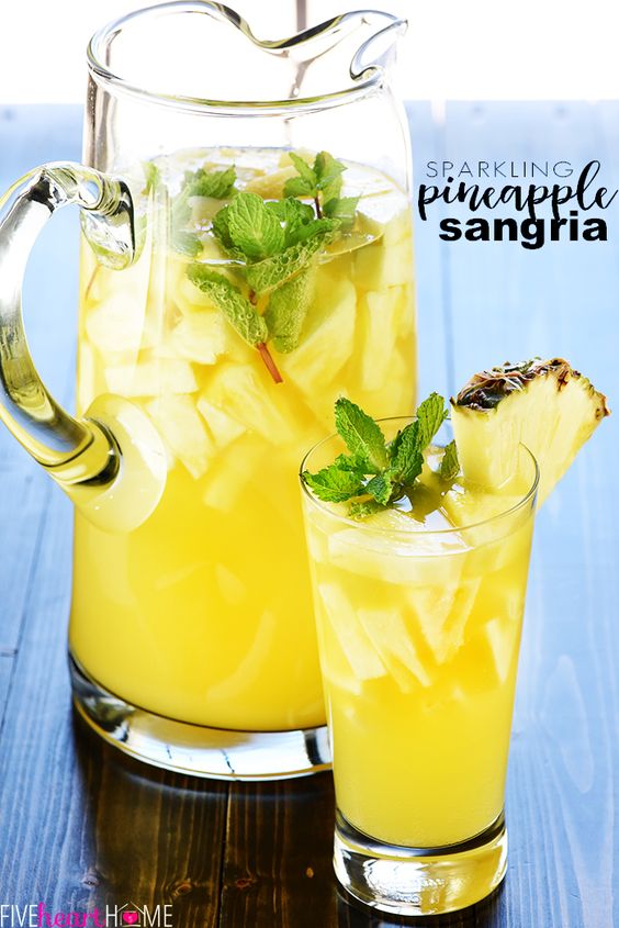 This Sparkling Pineapple Sangria is a delightful bubbly, refreshing 5 ingredient tropical summer cocktail. This cocktail belongs poolside at parties and bbq's this year! #summercocktails #SparklingPineappleSangria #PineappleSangria