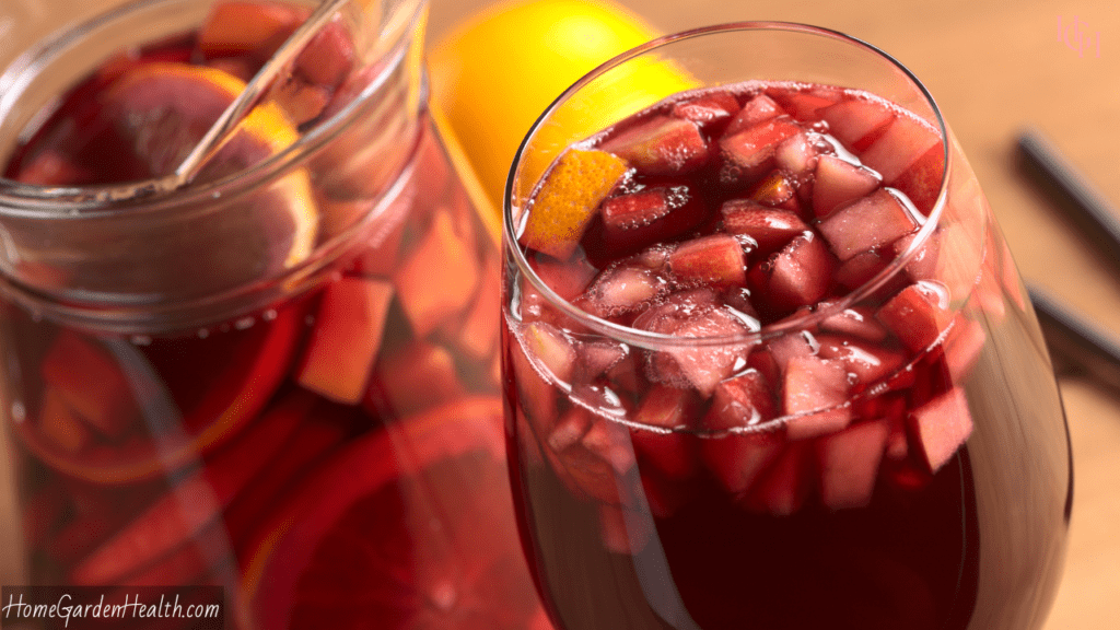 close up of a glass filled with red wine sangria diced fruits