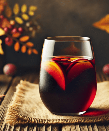 Red Wine Sangria in a tumbler with fall themed surroundings