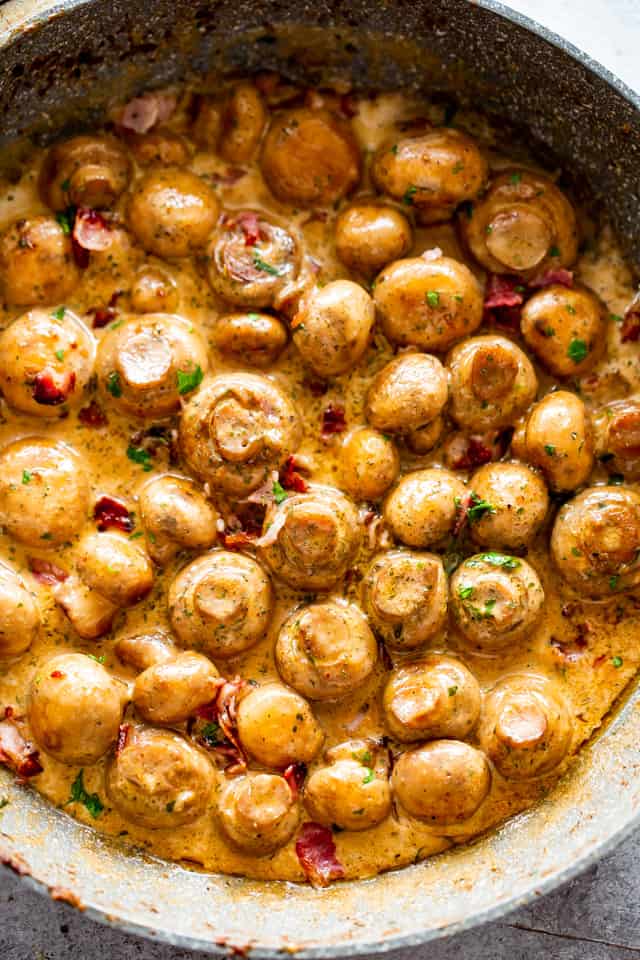 Garlic mushrooms with bacon in a pan